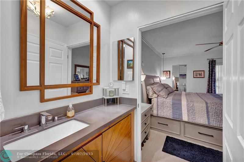 10999 Water Oak Manor Boca Raton, FL 33498 - Photo 32 of 49 a en suite bathroom with a granite countertop sink and a mirror