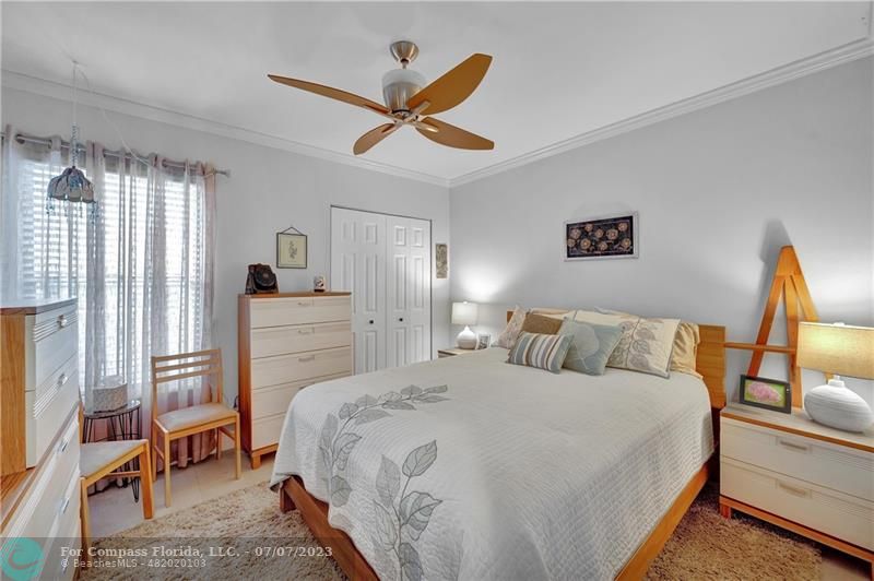 10999 Water Oak Manor Boca Raton, FL 33498 - Photo 35 of 49 a bedroom with a bed and a large mirror next to a window