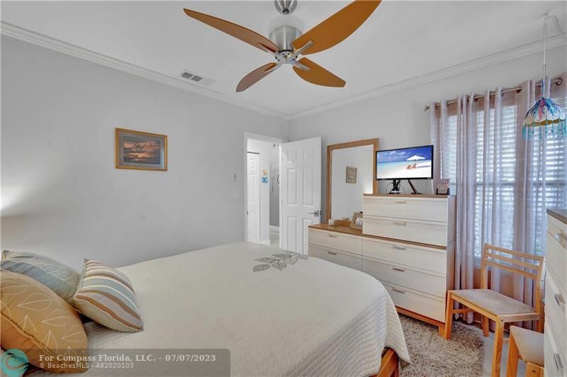 10999 Water Oak Manor Boca Raton, FL 33498 - Photo 36 of 49 a bedroom with a bed and wooden floor