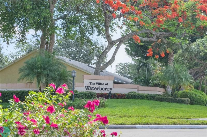 10999 Water Oak Manor Boca Raton, FL 33498 - Photo 5 of 49 a sign that is in front of flowers