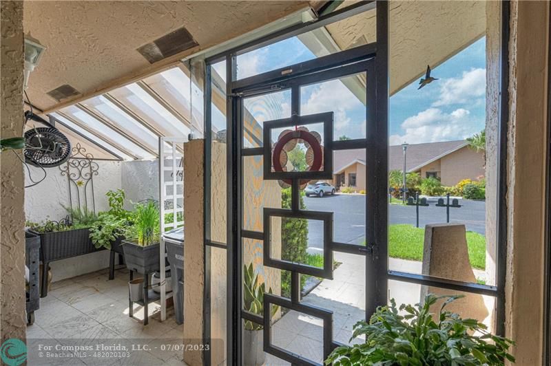 10999 Water Oak Manor Boca Raton, FL 33498 - Photo 6 of 49 a front view of a house with a porch