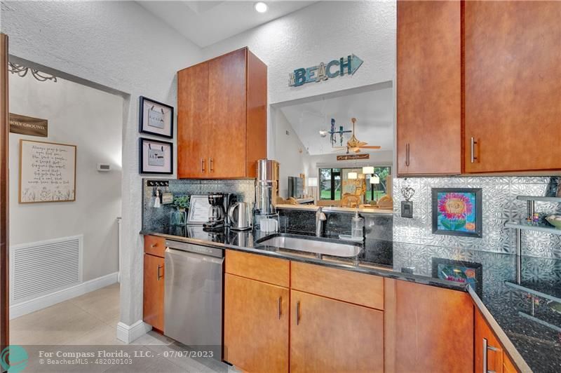 10999 Water Oak Manor Boca Raton, FL 33498 - Photo 9 of 49 a kitchen with stainless steel appliances a sink a stove and cabinets