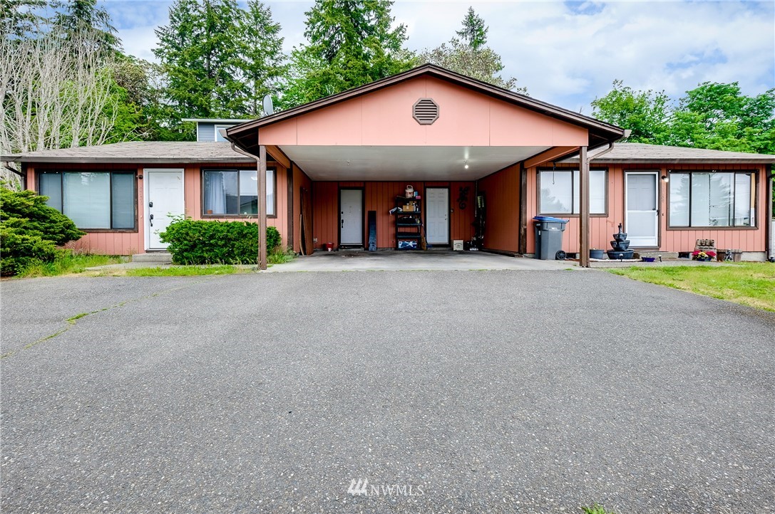 2734 Pine Road Northeast Bremerton, WA 98310 - Photo 1 of 17 a front view of a house with a yard and garage