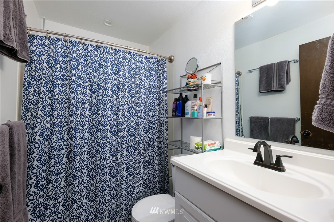 2734 Pine Road Northeast Bremerton, WA 98310 - Photo 14 of 17 a bathroom with a sink toilet and vanity