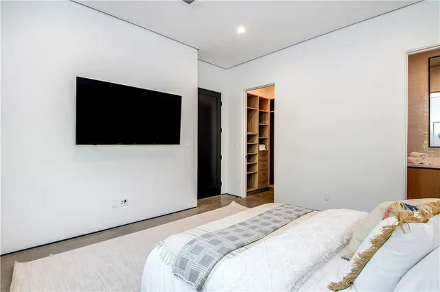 a bedroom with a large bed and a large window