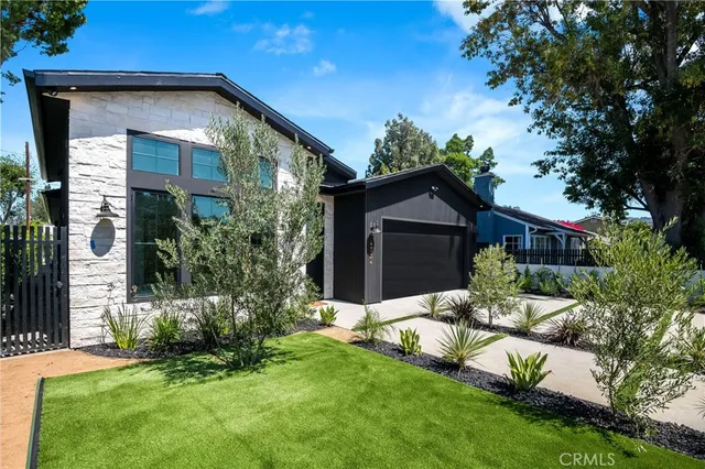 a view of a house with a yard and plants