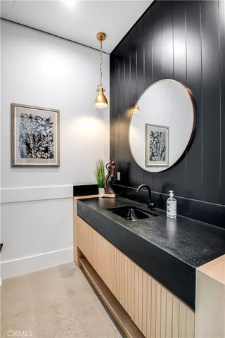 a dining hall with stainless steel appliances kitchen island a table chairs and a kitchen view