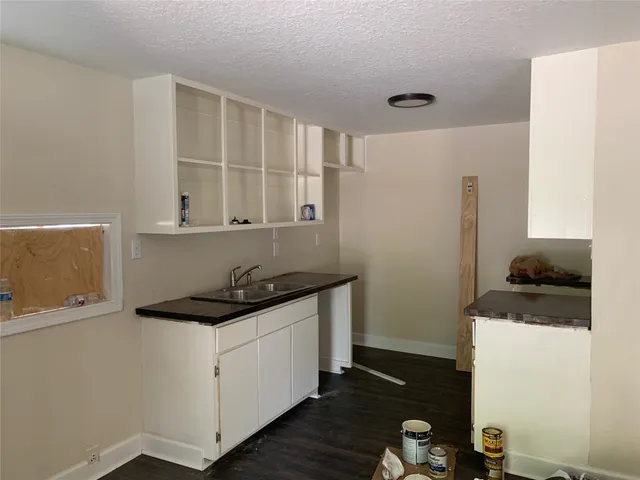 a kitchen with a sink and cabinets
