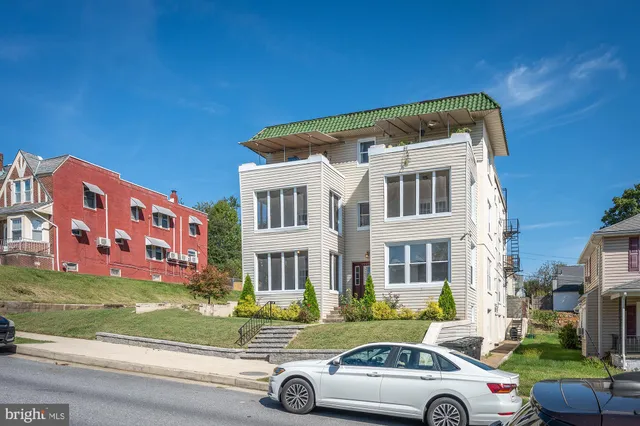 a view of a cars park in front of a building