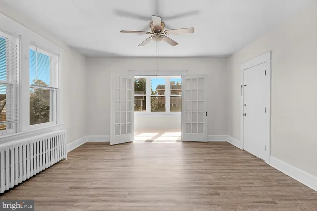 wooden floor in an empty room with a window
