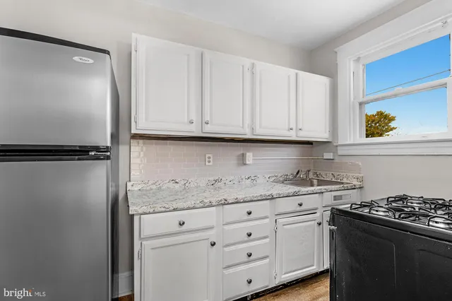 a kitchen with granite countertop cabinets and steel stainless steel appliances