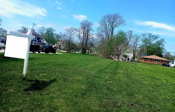 a view of a garden with large trees