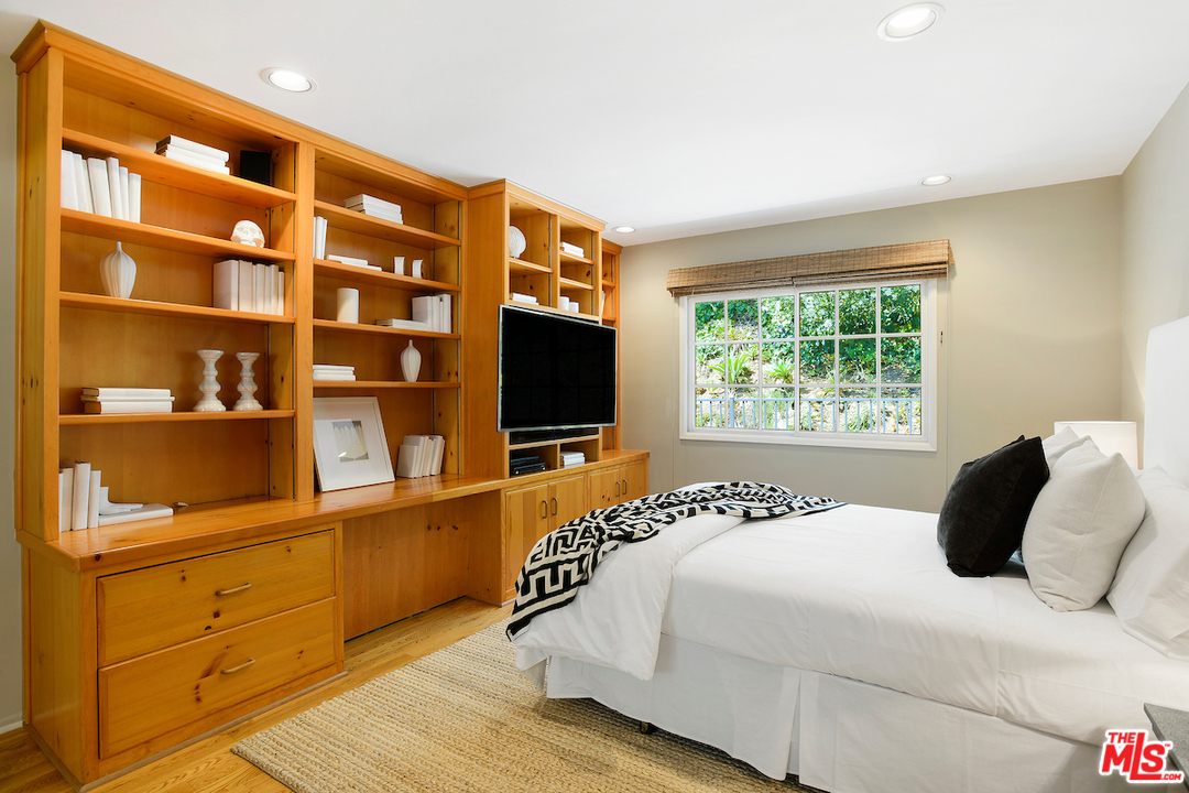 9573 Stuart Lane Beverly Hills, CA 90210 - Photo 11 of 24 a bedroom with a bed and a flat screen tv
