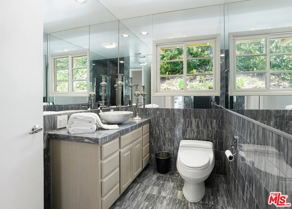 9573 Stuart Lane Beverly Hills, CA 90210 - Photo 12 of 24 a bathroom with a toilet sink and mirror