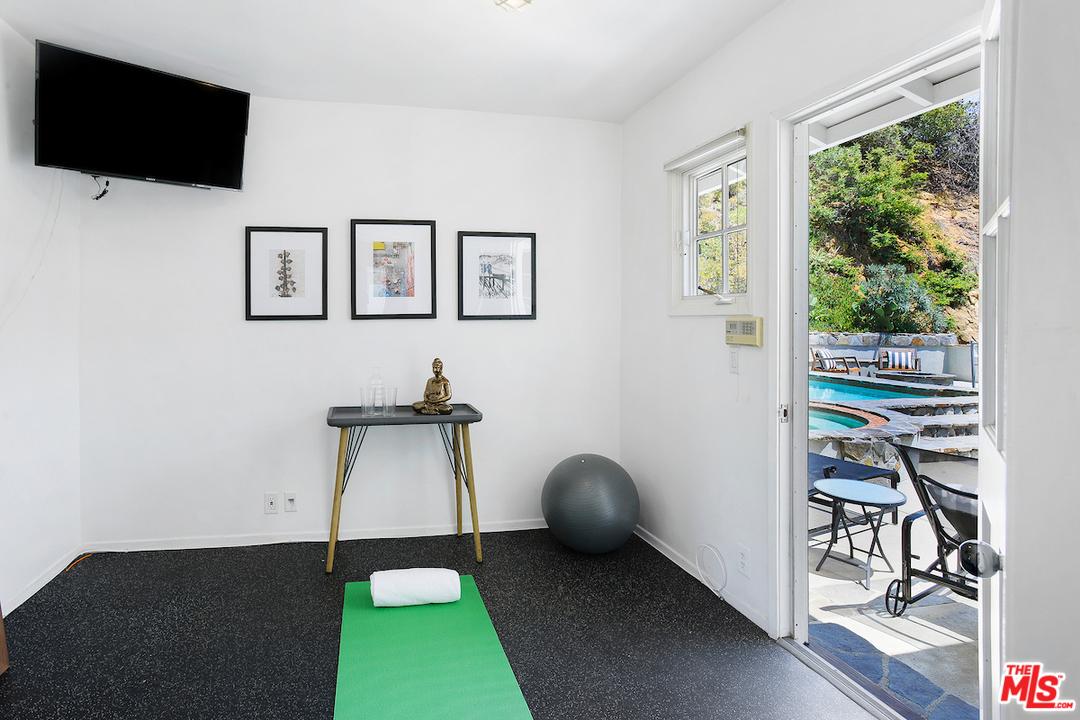 9573 Stuart Lane Beverly Hills, CA 90210 - Photo 16 of 24 a living room with furniture and a flat screen tv