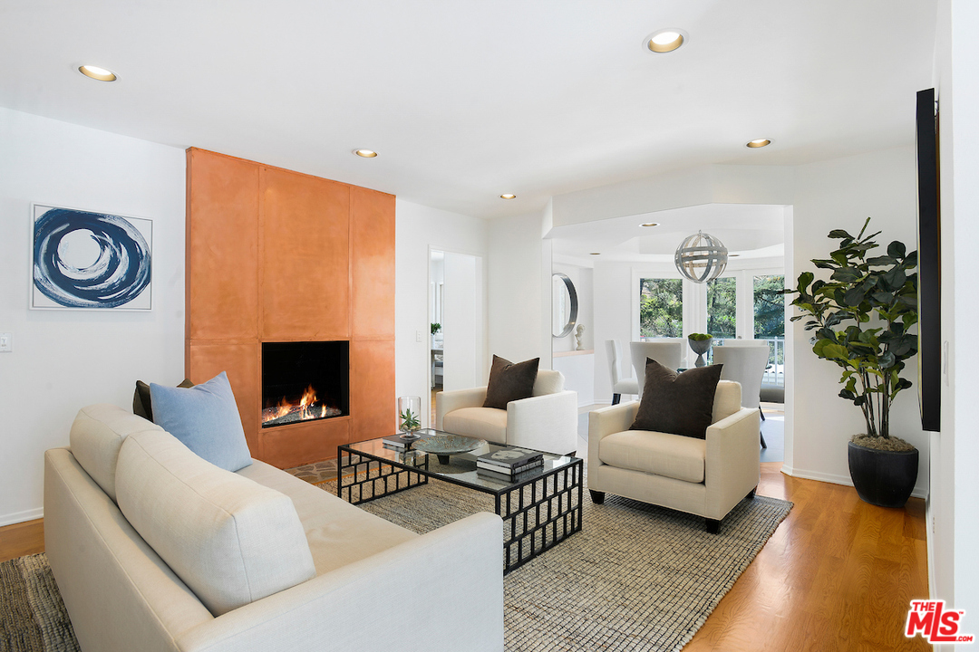 9573 Stuart Lane Beverly Hills, CA 90210 - Photo 3 of 24 a living room with furniture and a fireplace