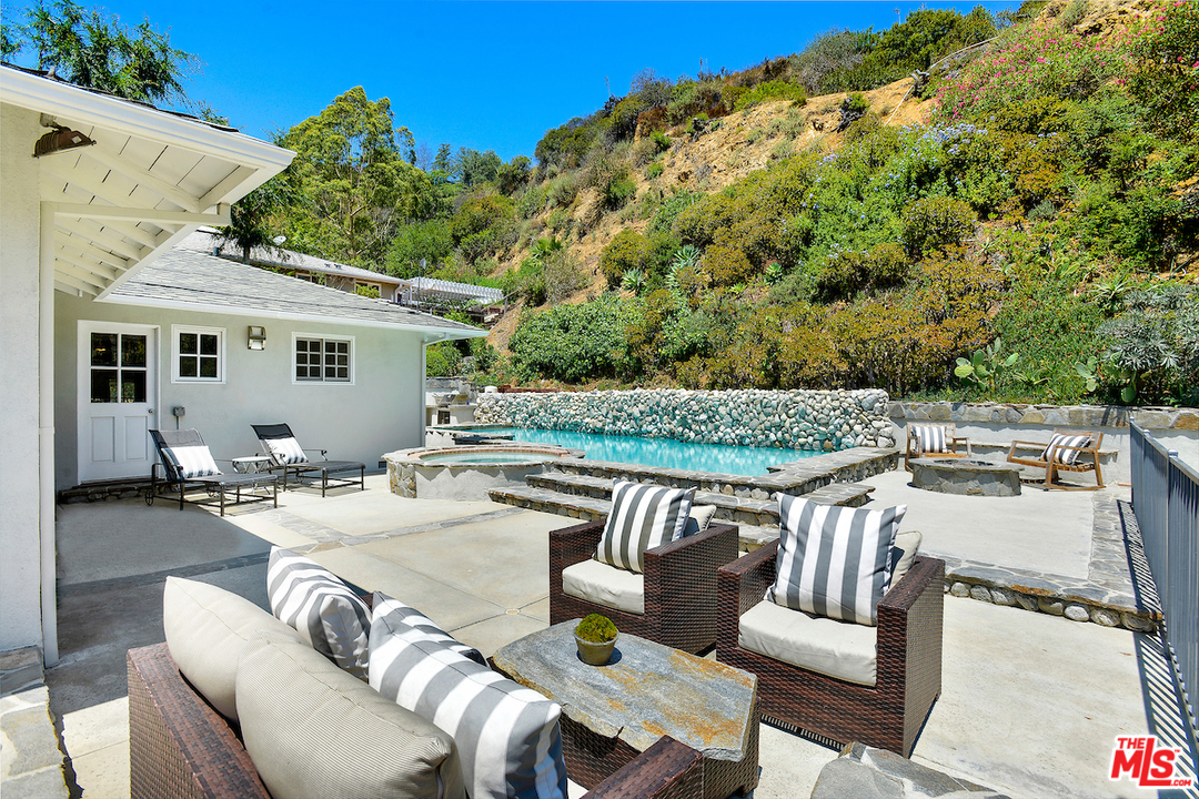 9573 Stuart Lane Beverly Hills, CA 90210 - Photo 22 of 24 a view of a patio with couches table and chairs and potted plants