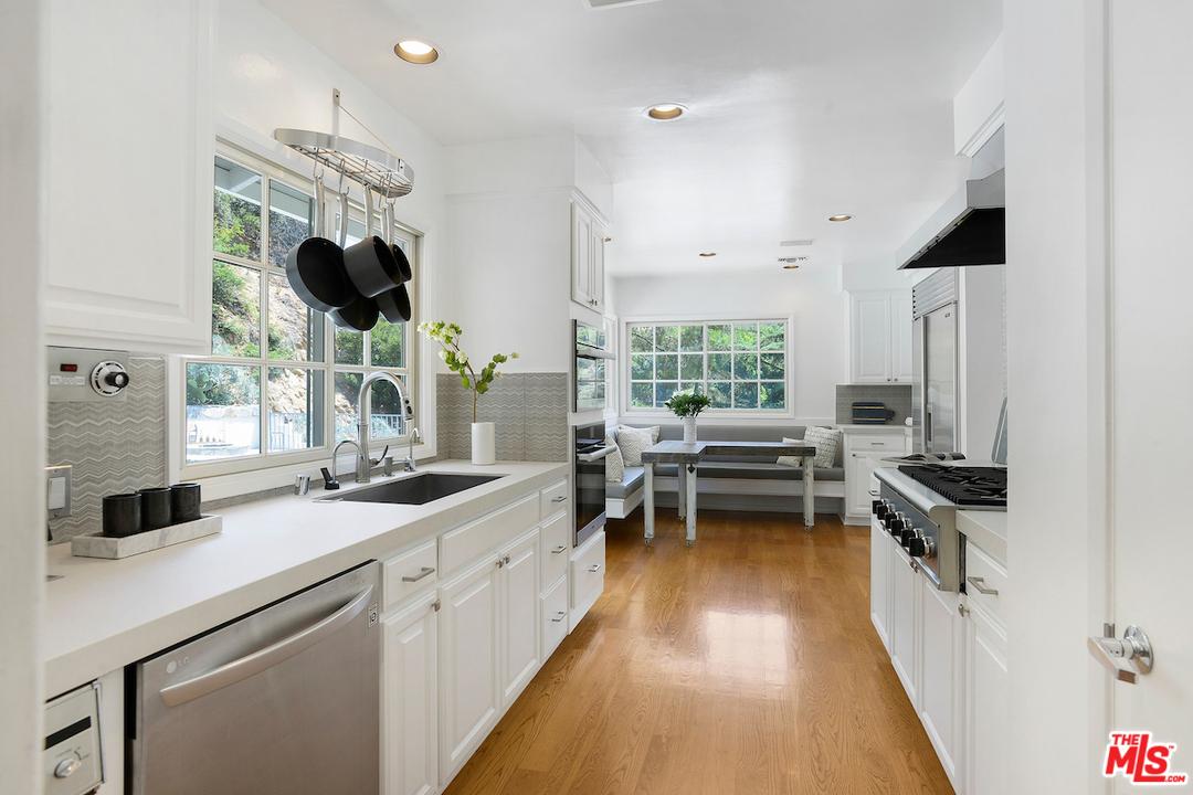 9573 Stuart Lane Beverly Hills, CA 90210 - Photo 6 of 24 a kitchen with a stove a sink and a refrigerator