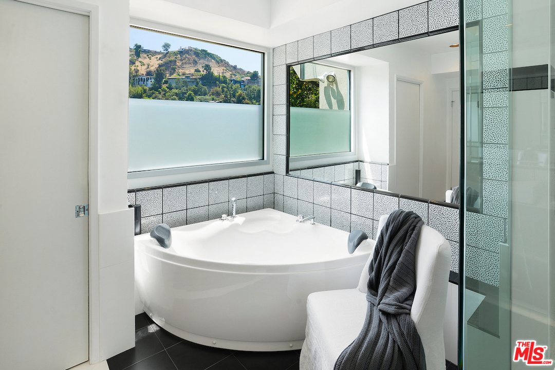9573 Stuart Lane Beverly Hills, CA 90210 - Photo 10 of 24 a white bath tub sitting next to a window