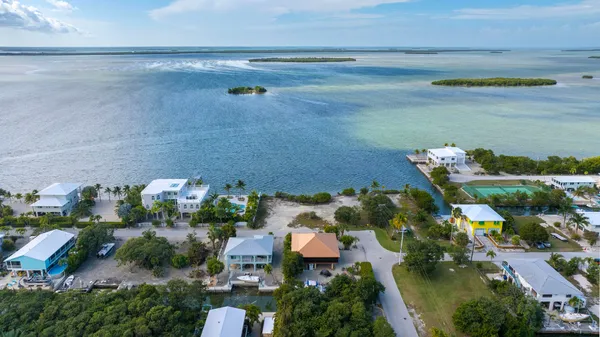 an aerial view of a house with a lake view