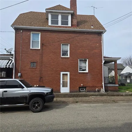 a front view of a house with parking space