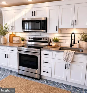 a kitchen with stainless steel appliances a stove a microwave sink and cabinets