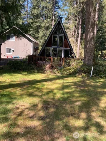 a view of a house with pool yard and a tree