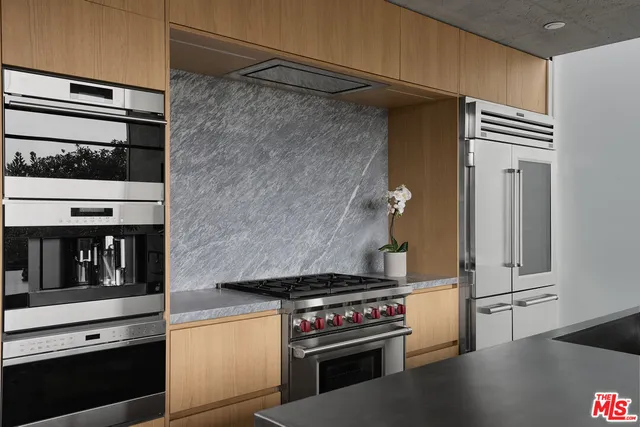 a kitchen with a stove and a refrigerator