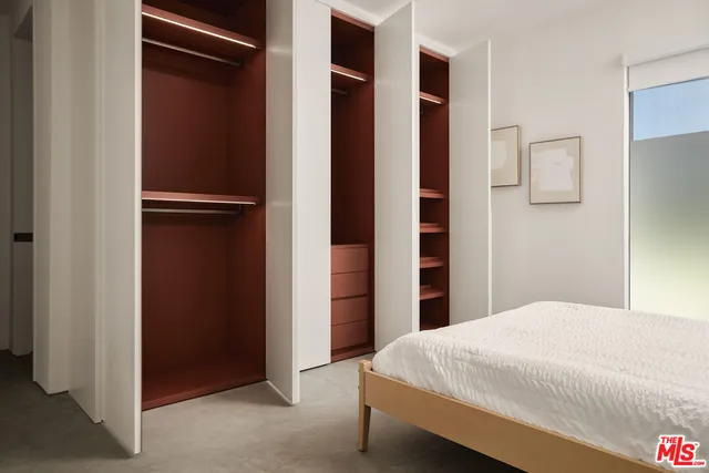 a bedroom with a bed and a walk in closet