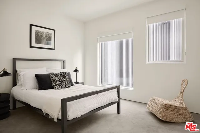 a bedroom with a bed and a chair