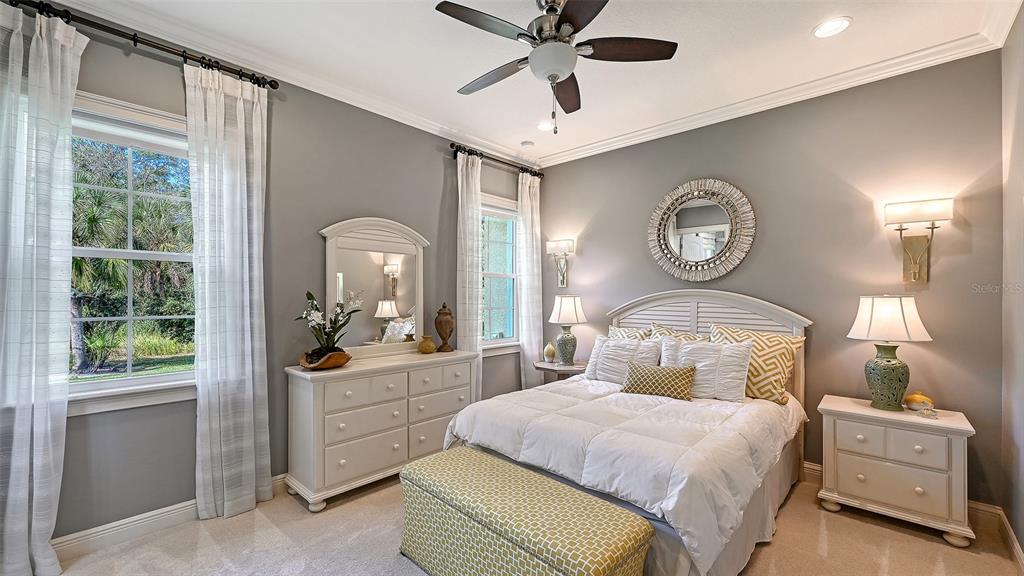 9489 Swaying Branch Road Sarasota, FL 34241 - Photo 14 of 37 a bedroom with a bed and a large window