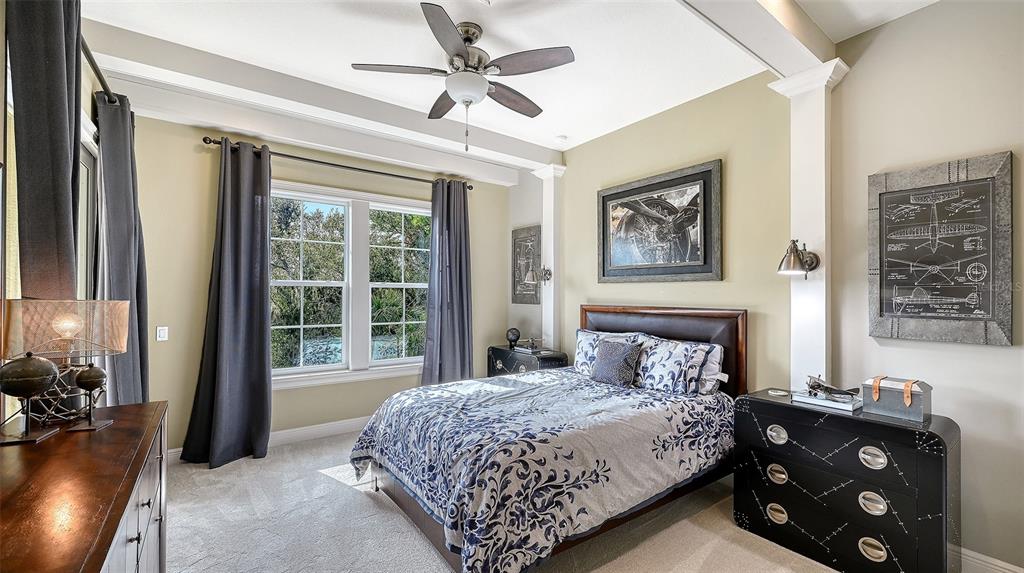 9489 Swaying Branch Road Sarasota, FL 34241 - Photo 21 of 37 a bedroom with a bed and a large mirror