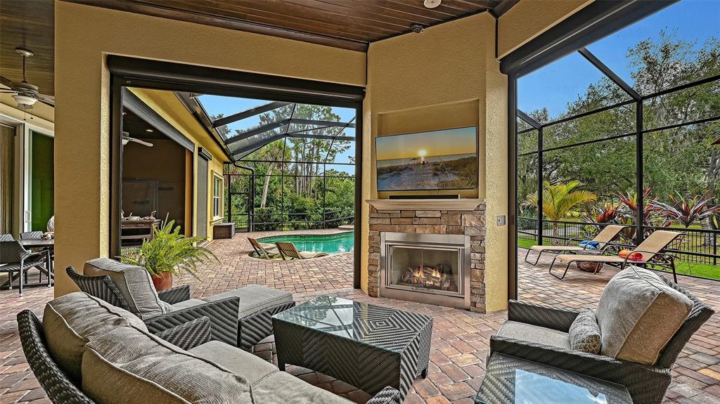 9489 Swaying Branch Road Sarasota, FL 34241 - Photo 23 of 37 a outdoor living space with furniture and a fireplace