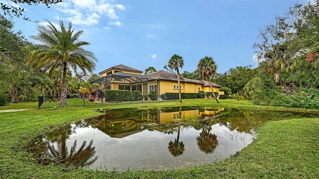 9489 Swaying Branch Road Sarasota, FL 34241 - Photo 26 of 37 a view of a house with a yard and swimming pool