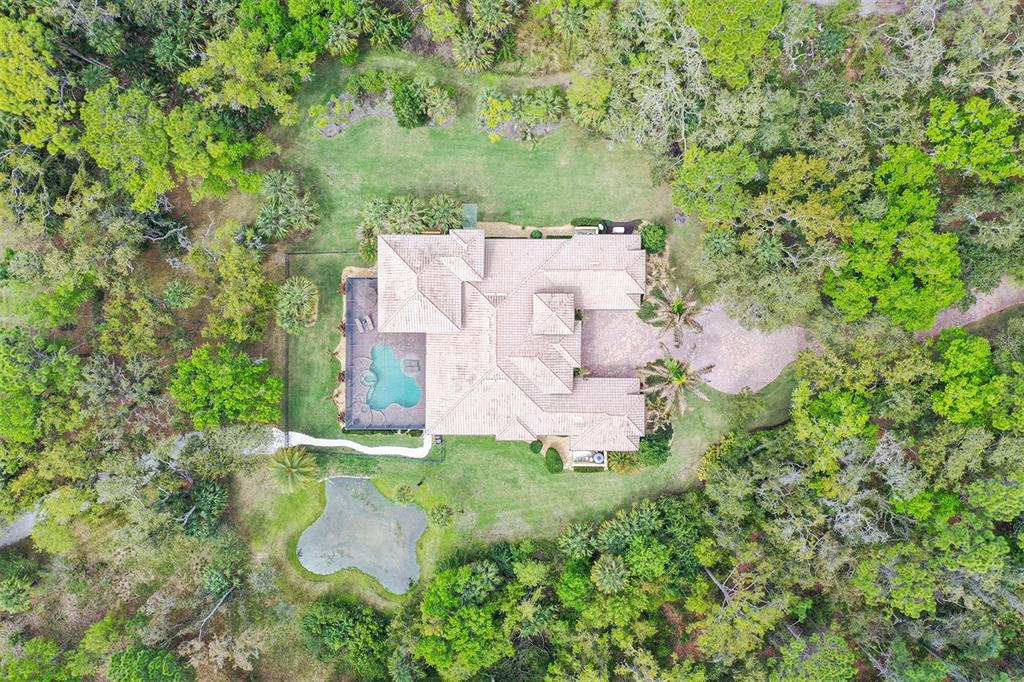 9489 Swaying Branch Road Sarasota, FL 34241 - Photo 29 of 37 an aerial view of residential house with outdoor space and trees all around