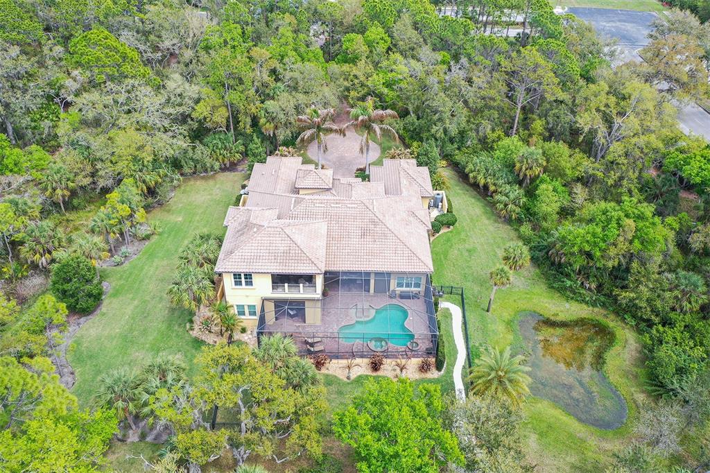 9489 Swaying Branch Road Sarasota, FL 34241 - Photo 30 of 37 an aerial view of a house with a yard and large trees
