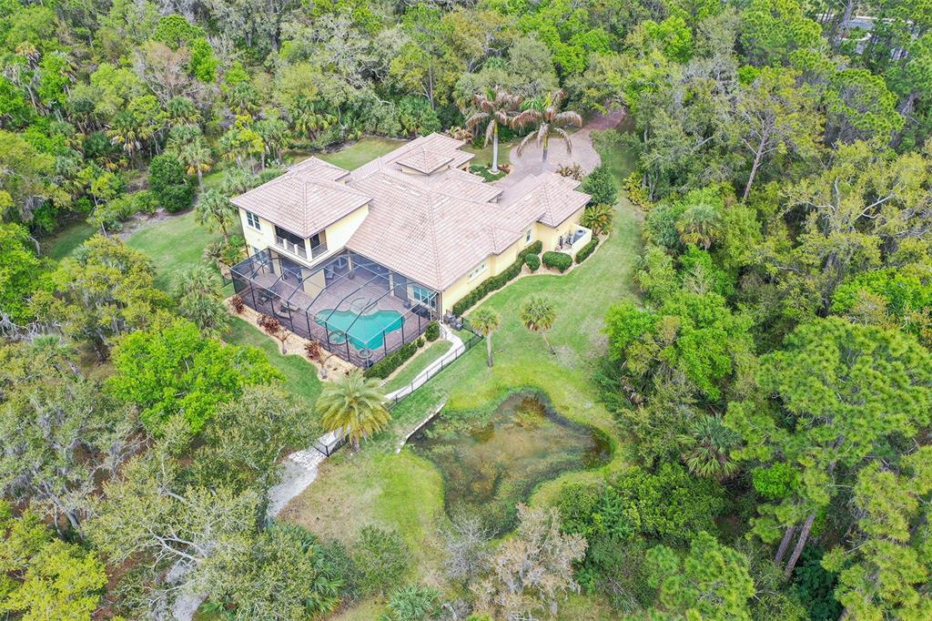 9489 Swaying Branch Road Sarasota, FL 34241 - Photo 31 of 37 an aerial view of a house with yard