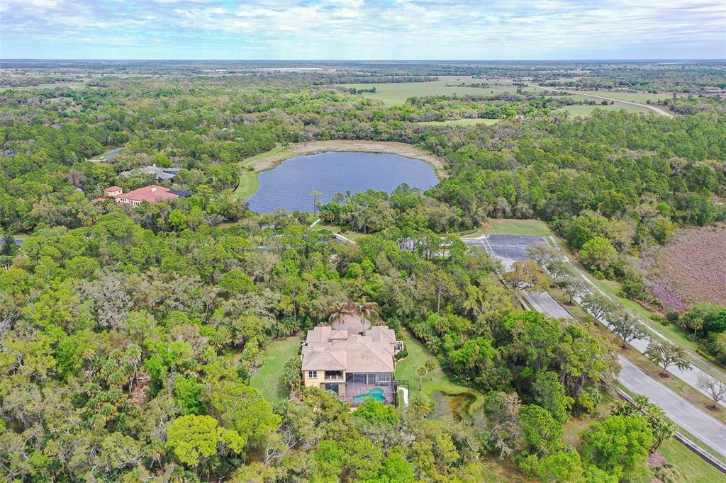 9489 Swaying Branch Road Sarasota, FL 34241 - Photo 33 of 37 an aerial view of a house with a yard