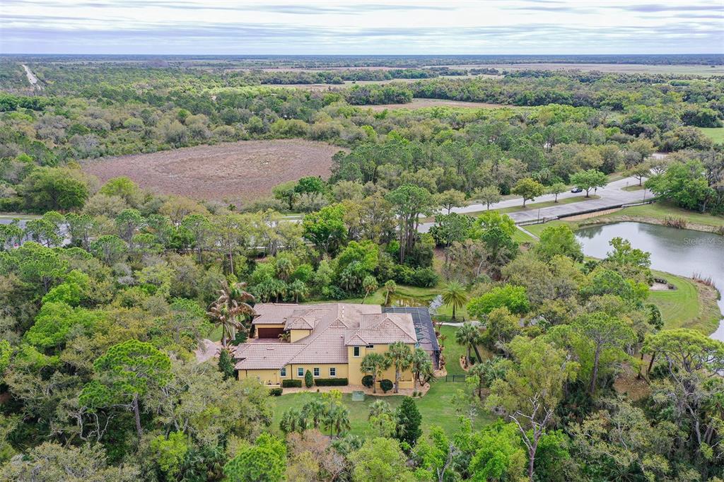 9489 Swaying Branch Road Sarasota, FL 34241 - Photo 35 of 37 an aerial view of a house with a yard