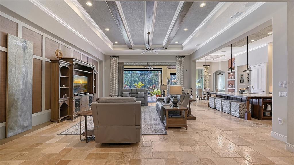 9489 Swaying Branch Road Sarasota, FL 34241 - Photo 4 of 25 a living room with furniture a fireplace and large windows