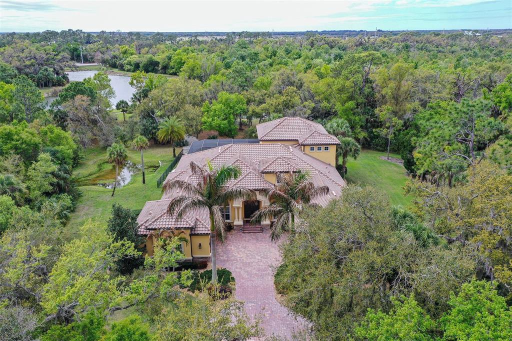 9489 Swaying Branch Road Sarasota, FL 34241 - Photo 4 of 37 an aerial view of a house with yard and outdoor seating