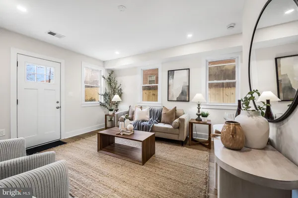 a living room with furniture and wooden floor