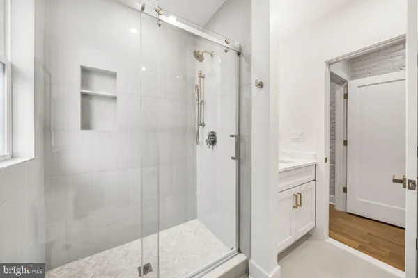 a bathroom with a shower and a sink