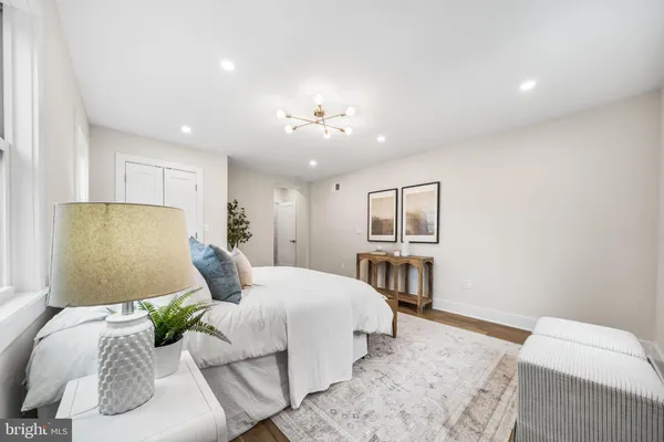 a bedroom with a bed and a chandelier