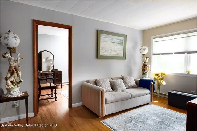 a bedroom with a bed and a mirror on dresser