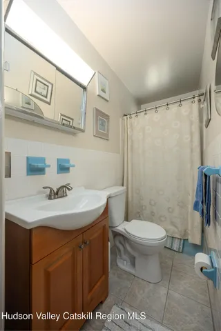 a bathroom with a toilet a sink and a mirror