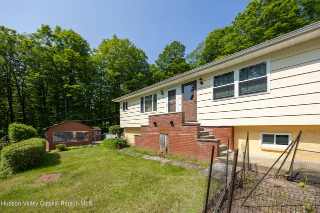 a front view of house with yard and green space