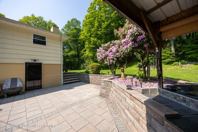 a view of a chairs and table in the back yard of the house