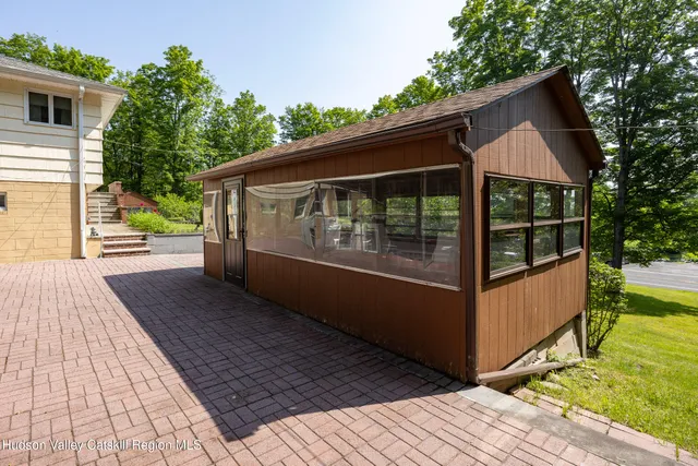 a view of house with backyard and garden