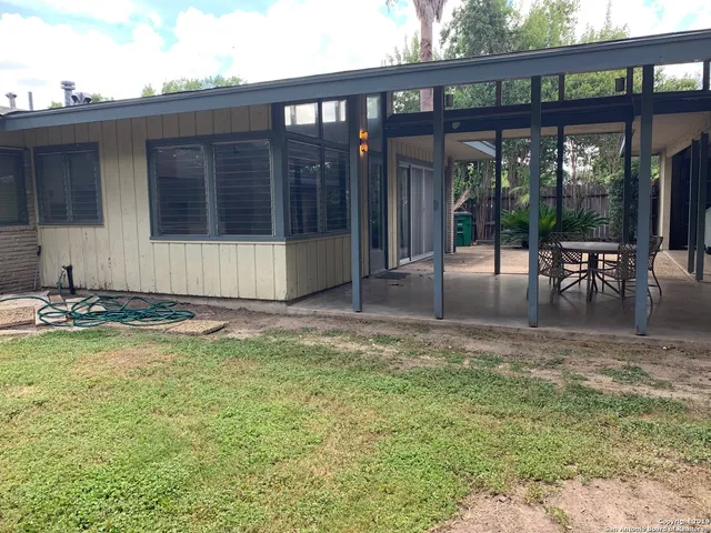 a view of a house with backyard porch and sitting area